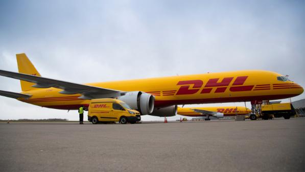 A DHL plane picking up goods for express shipping A DHL plane picking up goods for express shipping