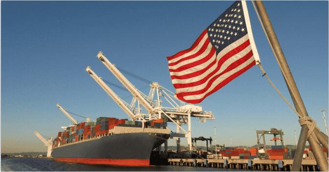 A Ship Docked at the Seaport and the US Flag A Ship Docked at the Seaport and the US Flag